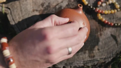 Close-up. man's hand closes the lid of a clay teapot Stock Footage 229859167