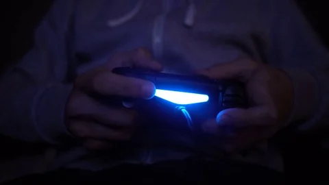 Close-up man's hand with controller, game pad. Man play at night Stock Footage 73740586