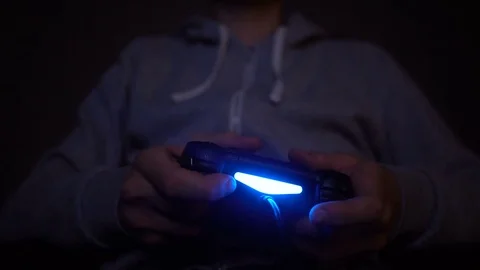 Close-up man's hand with controller, game pad. Man play at night Stock Footage 73743716