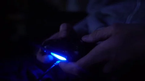 Close-up man's hand with controller, game pad. Man play at night Stock Footage 73744747
