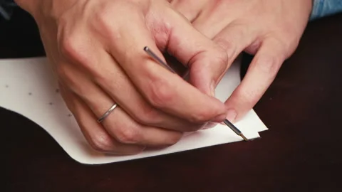 Close up man's hand cutting out of leather with a special knife of the sizes Stock Footage 138260498