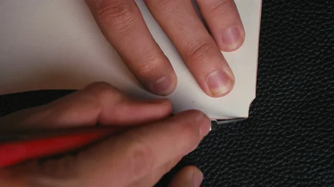 Close up man's hand cutting out of leather with a special knife of sizes under Stock Footage 138307898