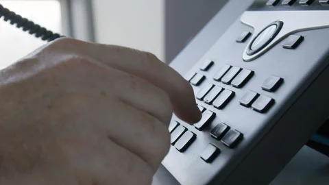 Close up of man's hand dialing desktop telephone Vídeos de archivo 124232820