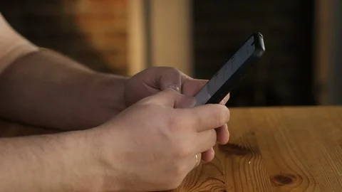 Close-up of a man's hand dialing a number on a cell phone with his fingers. Stock Footage 128095142