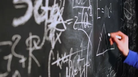 Close-up of man's hand drawing triangle and graphic on blackboard full of math's Stock Footage 146752723