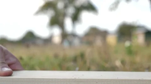 Close-up man's hand driving nails into a wooden board with a hammer Stock Footage 253224422