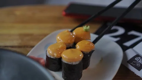 Close-up of a man’s hand eating delicious cheese sushi rolls. Stock Footage 297634647