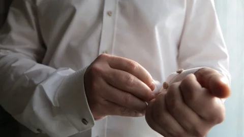 Close up of man's hand fastening a cuff before getting married. Wedding detail Stock Footage 121079802