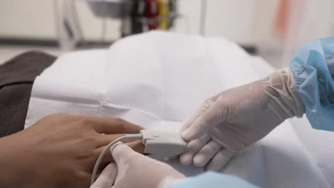 Close up on man's hand with heart rate monitor clipper on finger. Stock Footage 249265332