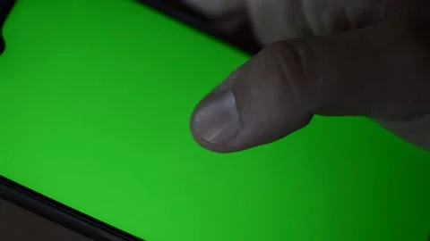 Close-up man's hand holding apple iphone with green screen 動画素材 200821070