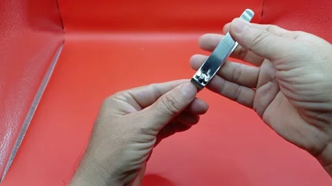 Close-up of man's hand holding clippers and cutting his nails. Stock Footage 266475337