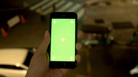 Close up of a Mans Hand Holding Green Mock up Screen Smartphone with tracking Stock-Footage 336585741