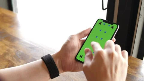 Close up of a Mans Hand Holding Green Mock up Screen Smartphone with tracking Stock-Footage 336585742
