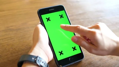 Close up of a Mans Hand Holding Green Mock up Screen Smartphone with tracking Video stock 336585743