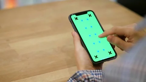 Close up of a Mans Hand Holding Green Mock up Screen Smartphone with tracking 스톡 동영상 336585749