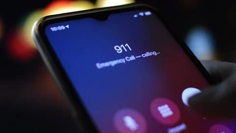 Close-up man's hand holding iphone and call 911 emergency number. 스톡 동영상 211824534
