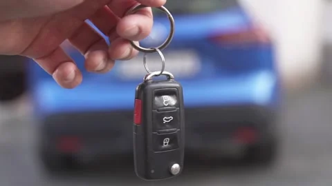 Close-up of a man's hand holding the keys of a newly purchased car Stock Footage 305657825