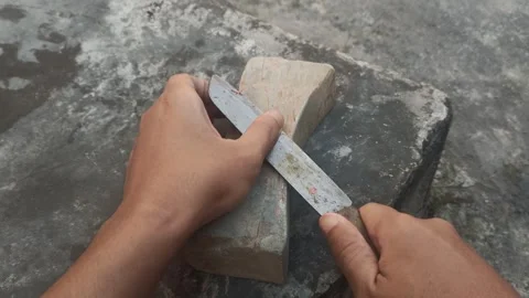 Close up of a man's hand holding a knife sharpening a blunt knife Video stock 313100577