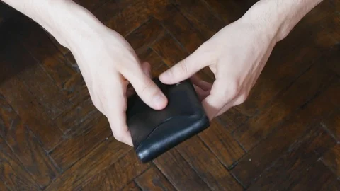 Close up of a man's hand holding leather wallet empty with no money. The conc Stock Footage 106197185