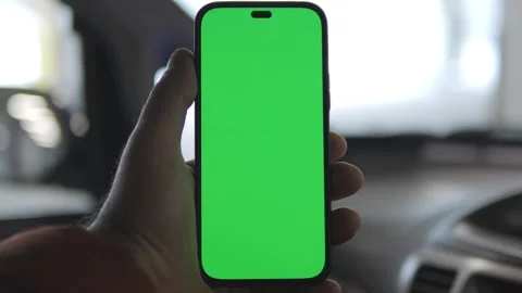 Close up of a man's hand holding a mobile telephone with a vertical green screen Stock Footage 267053888
