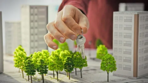 A close-up of a mans hand holding out shiny keys against the backdrop of 3D Stock Footage 341490249
