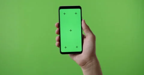 Close up of man's hand holding a smart phone with vertical green mock up chroma Stock Footage 137613963