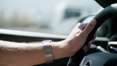 Close-up of a man's hand holding the steering wheel. Travel and journey. 库存影片 343737102