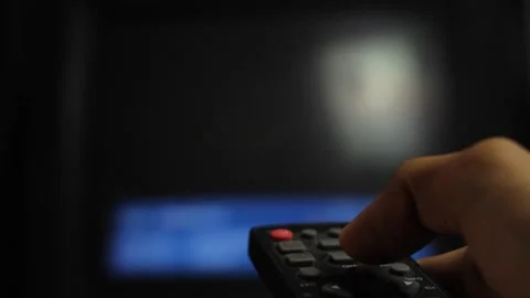 Close-up of a man's hand holding a TV remote control. Stock Footage 294699814