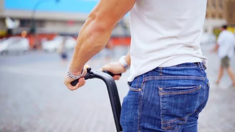 Close-up of a man's hand that holds behind the segways and slowly rides. Stockbeeldmateriaal 94646108
