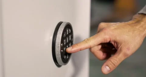 Close-up of a man's hand inserting a security code into the safe to open it. Stock Footage 156224709