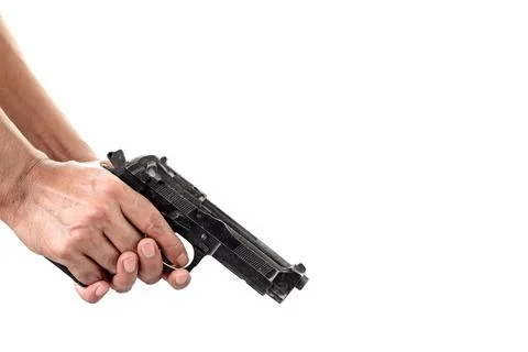Close-up of a man's hand inspecting and checking a gun with a loaded magazine Stock Photos