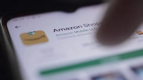 Close-up man's hand install and download amazon shopping app on the iphone. Stock-Footage 227314574