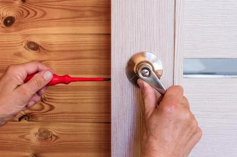 Close-up Of Man's Hand Installing Door Lock At Home Stock Photos