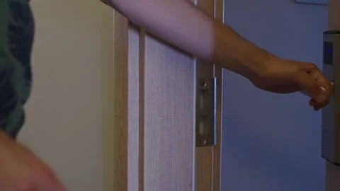 Close-up. A man's hand with a key card. A man opens the electronic lock of a Stock Footage 284206185