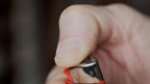 Close-up of man's hand lighting a lighter Stock Footage 129237840