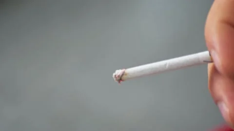 Close-up of a man's hand with a lit smoking cigarette Stock Footage 219893089
