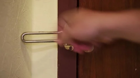 Close-Up Of Man's Hand Locking Deadbolt Lock At Hotel Stock Footage 312077469