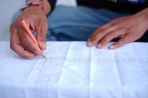 Close up of a man's hand making batik typical of the Bromo Tengger tribe. dra Stock Photos