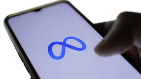Close-up man's hand with meta icon on his phone. cyberspace metaverse logo Stock Footage 196276363