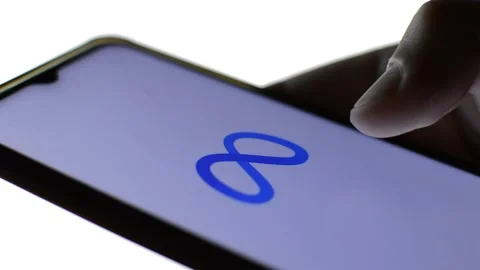 Close-up man's hand with meta icon on his phone. cyberspace metaverse logo Stock Footage 196276365