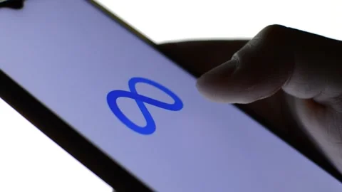 Close-up man's hand with meta icon on his phone. cyberspace metaverse logo Stock Footage 196276449