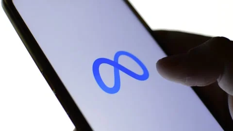 Close-up man's hand with meta icon on his phone. cyberspace metaverse logo Stock Footage 196276450