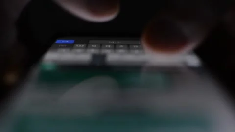 Close-up man's hand in night type on the iphone. phone message communication. 库存影片 230145305