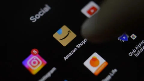 Close-up man's hand open amazon app on his phone. phone amazon app Video stock 201657627