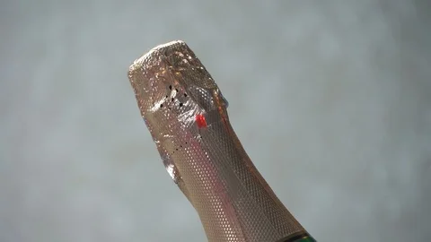 Close-up of a man’s hand opens a bottle of champagne, unwinds the wire. Stock Footage 121045224