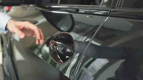 Close-up of man's hand opens car door Stock Footage 130843377