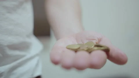 Close up of a man's hand opens a wallet and pours a few coins into his palm Stock Footage 209637591
