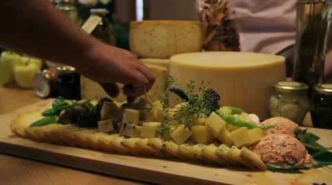 Close up of a man's hand picking served cheese from board Vidéo 27862960