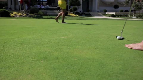 Close-up, a man's hand picks up a golf ball from a green field. Video stock 143923812