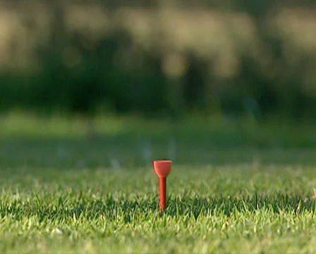 Close up of man's hand placing tee and golf ball and then hitting it Stock Footage 36431924